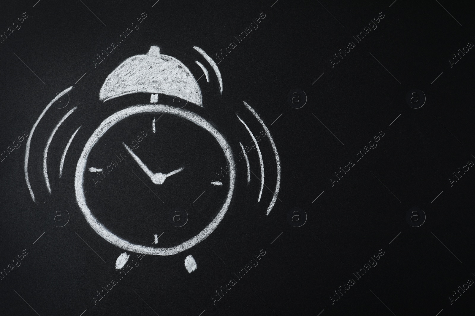 Photo of Alarm clock drawn on blackboard, space for text. School time