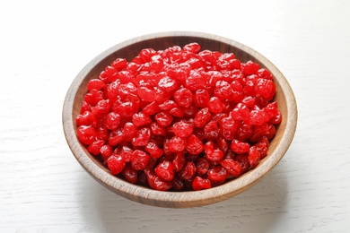 Bowl with tasty cherries on wooden background. Dried fruits as healthy food