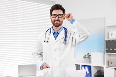 Medical consultant with glasses and stethoscope in clinic