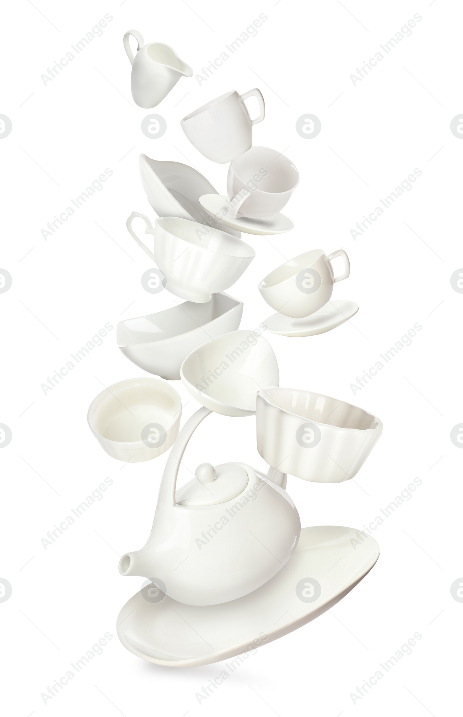 Image of Set of clean tableware in flight on white background