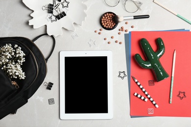 Set of accessories, cosmetics and tablet computer on grey background, flat lay. Beauty blogging