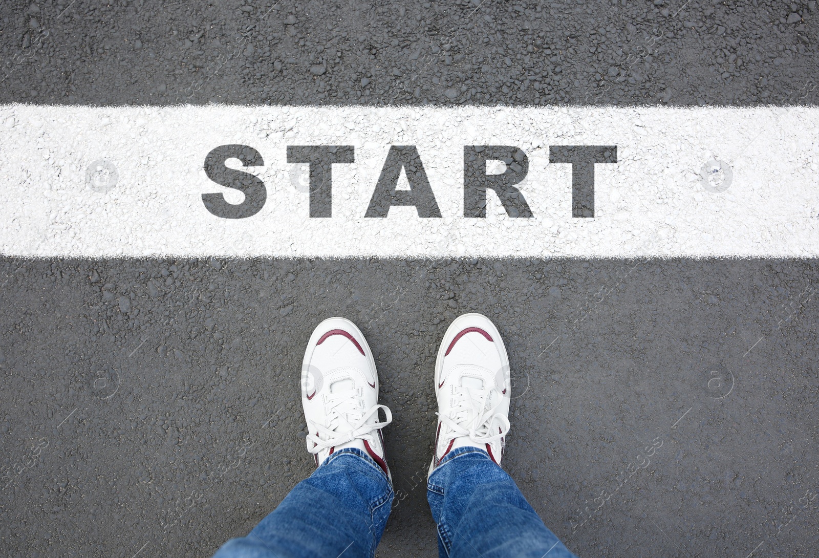 Image of New beginnings. Man standing near word Start on asphalt, top view