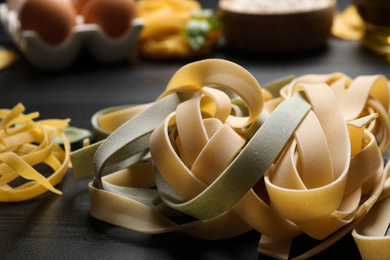 Tagliatelle pasta on grey wooden table, closeup