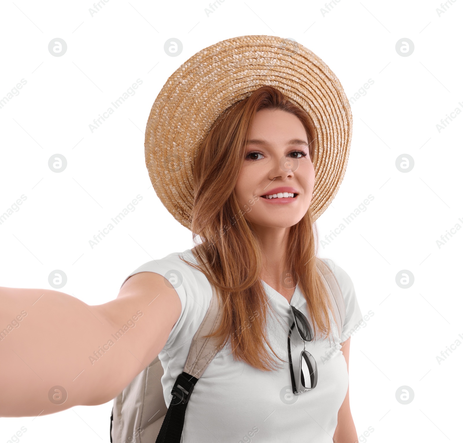 Photo of Beautiful woman in straw hat taking selfie on white background