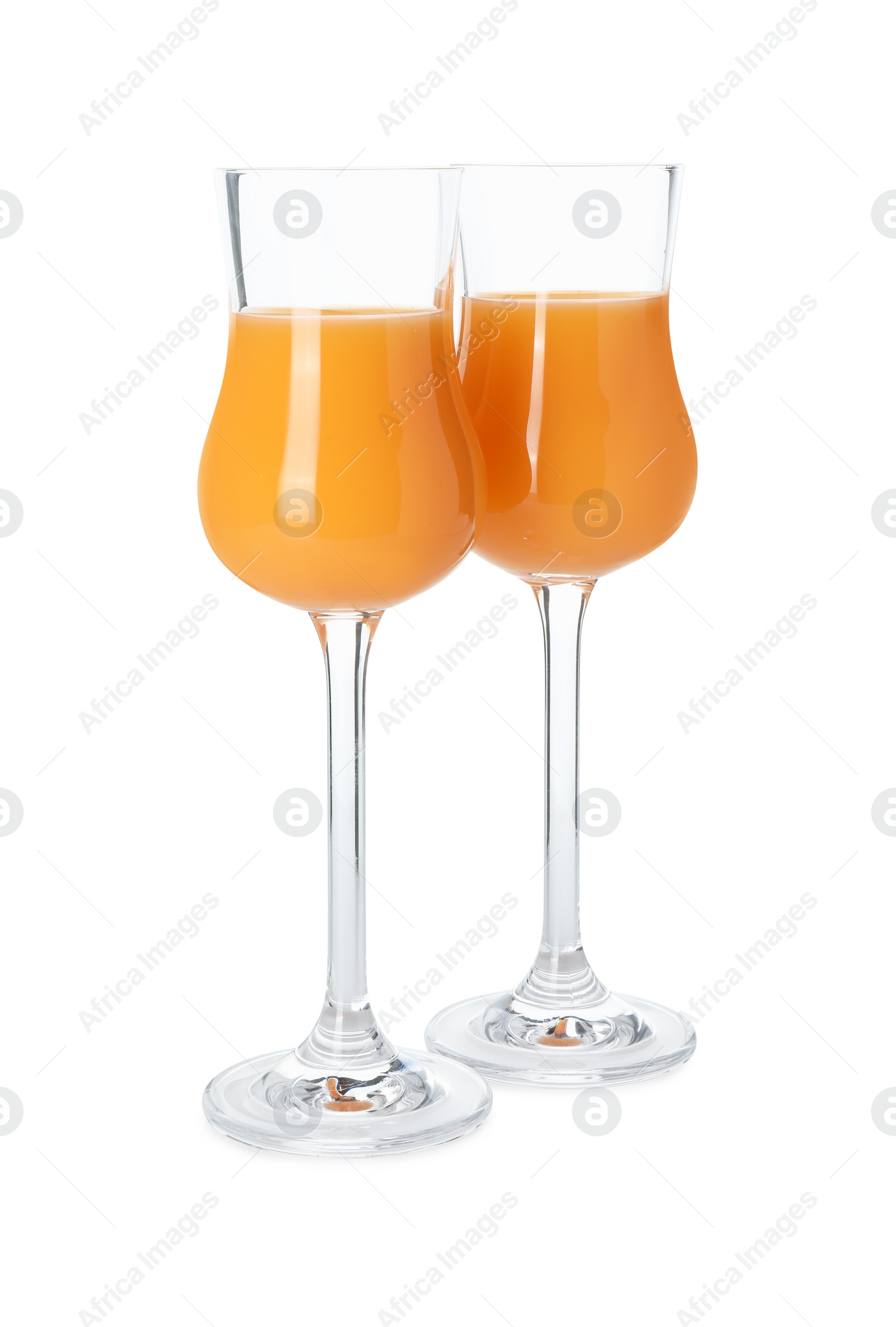 Photo of Glasses with tasty tangerine liqueur isolated on white