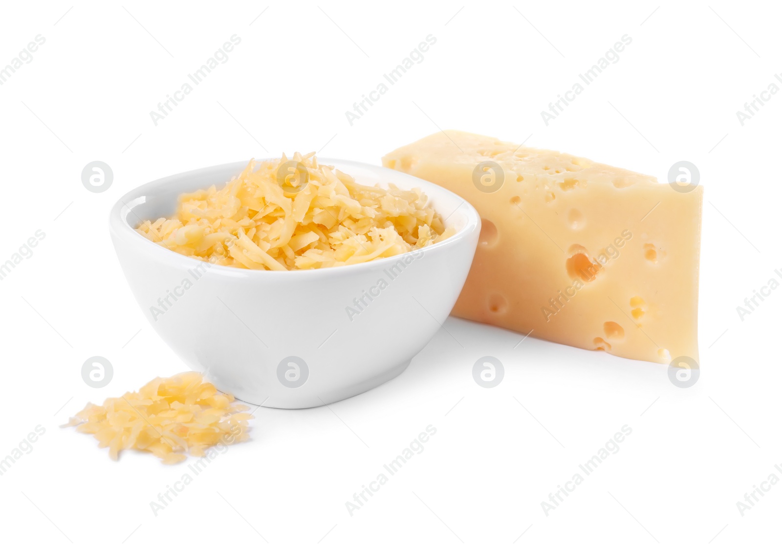 Photo of Grated cheese in bowl and piece of one isolated on white