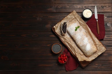 Photo of Delicious strudel with tasty filling served on wooden table, flat lay. Space for text