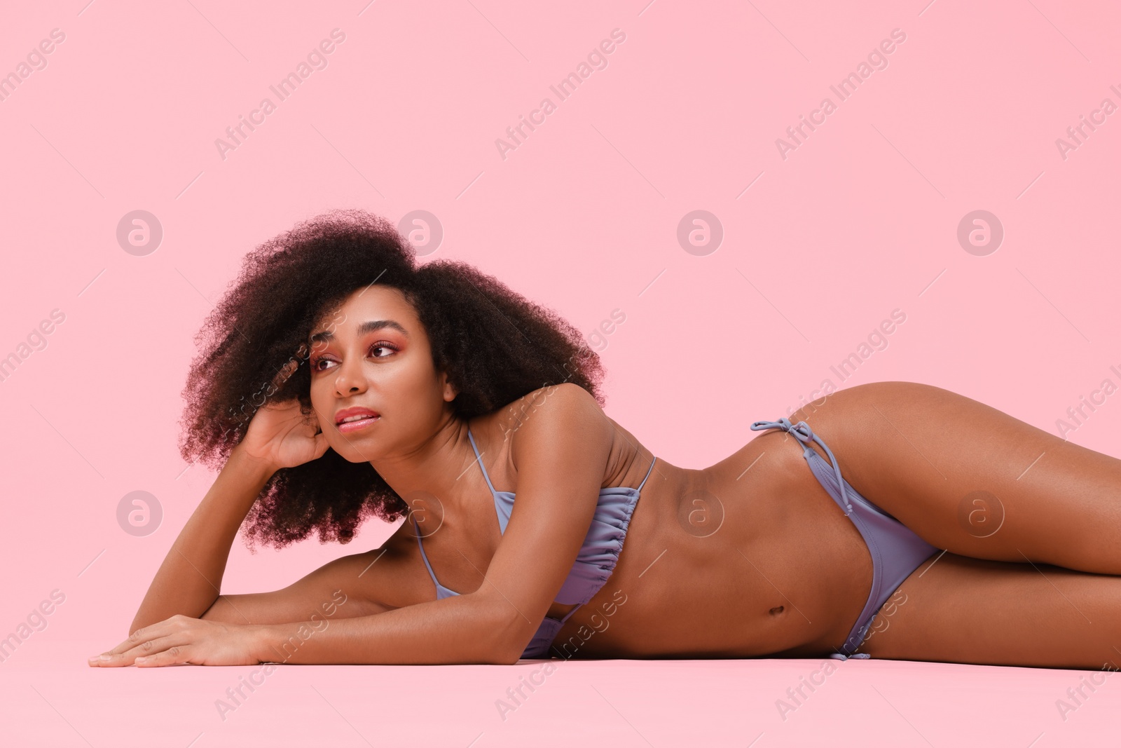 Photo of Beautiful woman in stylish bikini posing on pink background