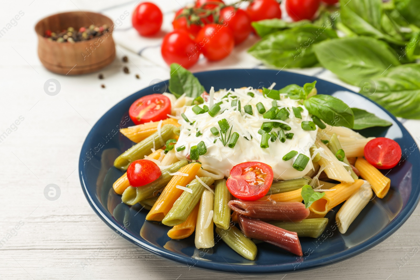 Photo of Delicious pasta with sour cream on white wooden table