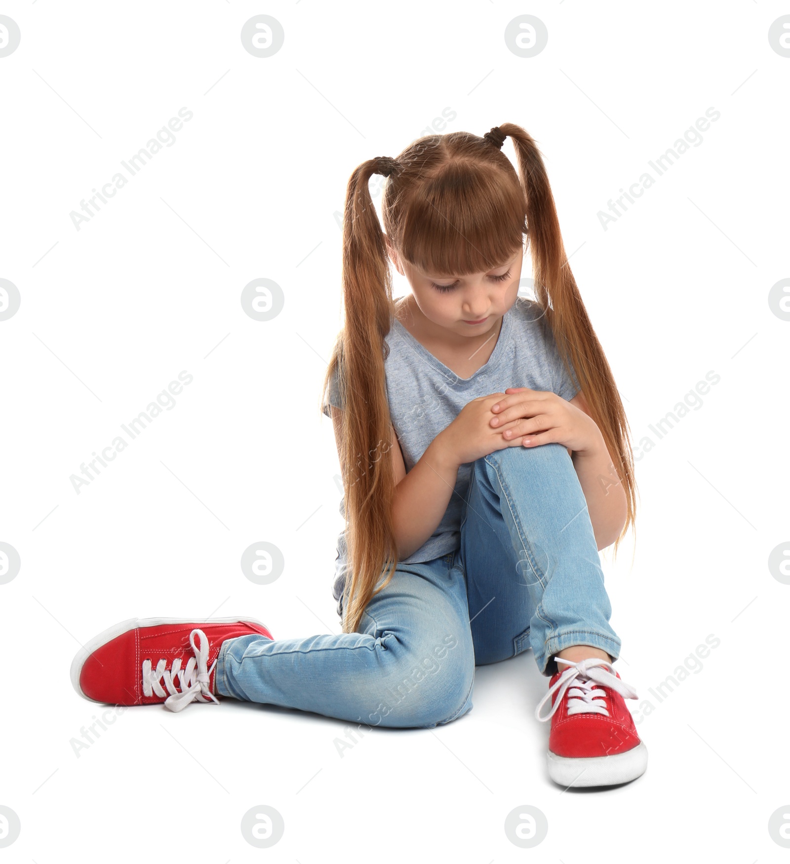 Photo of Full length portrait of little girl with knee problems sitting on white background