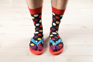 Man in socks and slippers on floor, closeup