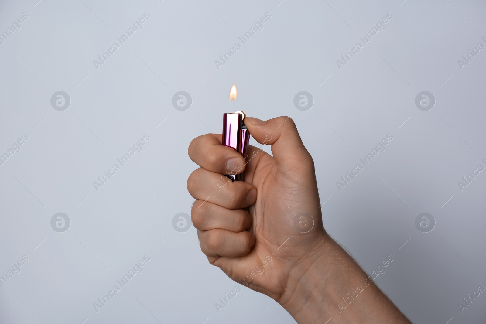 Photo of Man holding lighter on white background, closeup