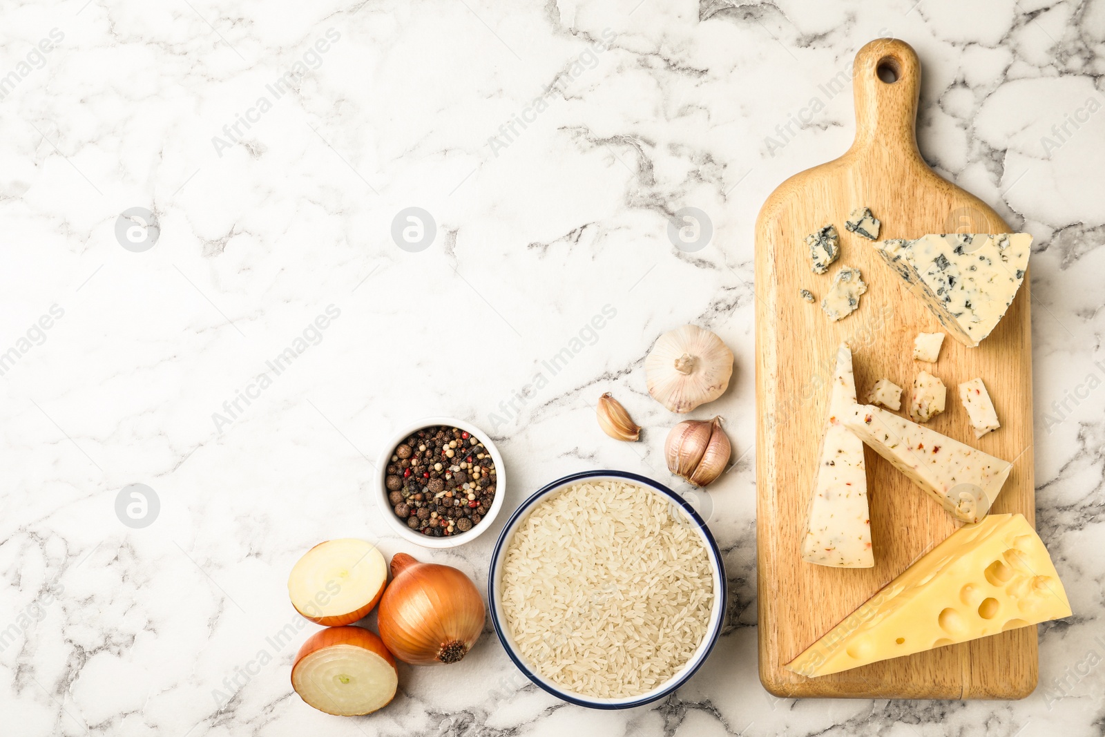 Photo of Flat lay composition with different ingredients on marble table, space for text. Risotto recipe