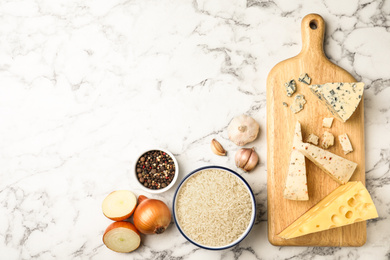 Flat lay composition with different ingredients on marble table, space for text. Risotto recipe