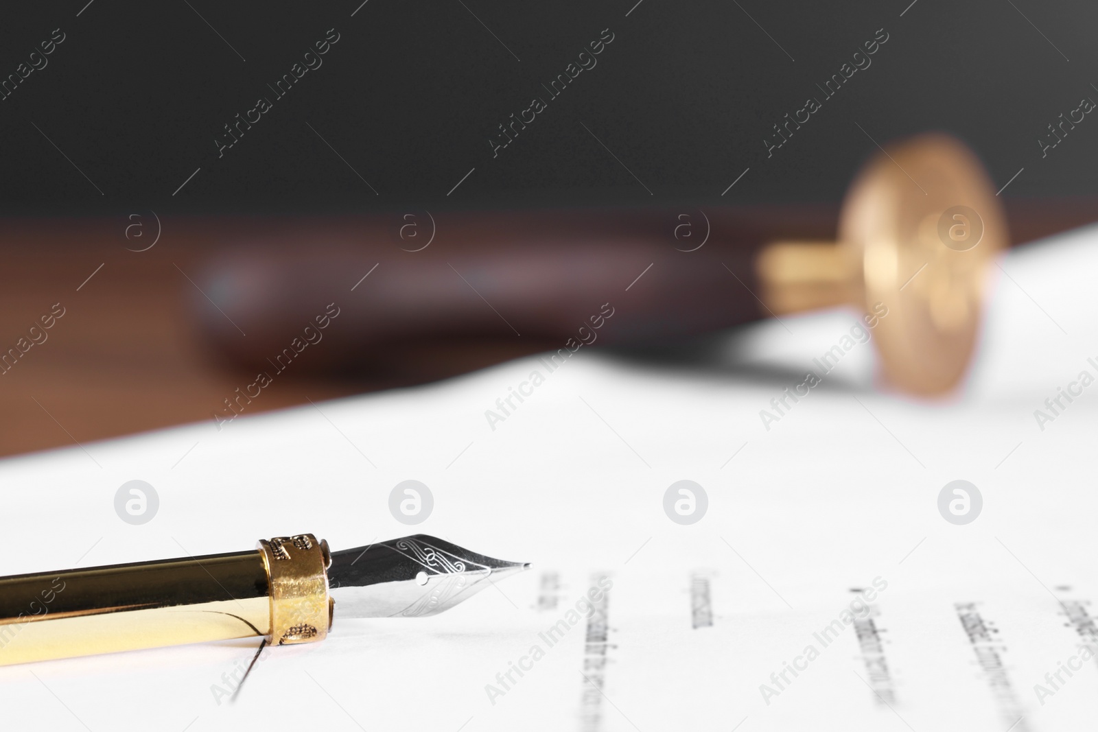 Photo of Fountain pen and paper document on table, closeup with space for text. Notary service