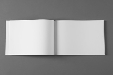 Photo of Open blank brochure on light grey background, top view