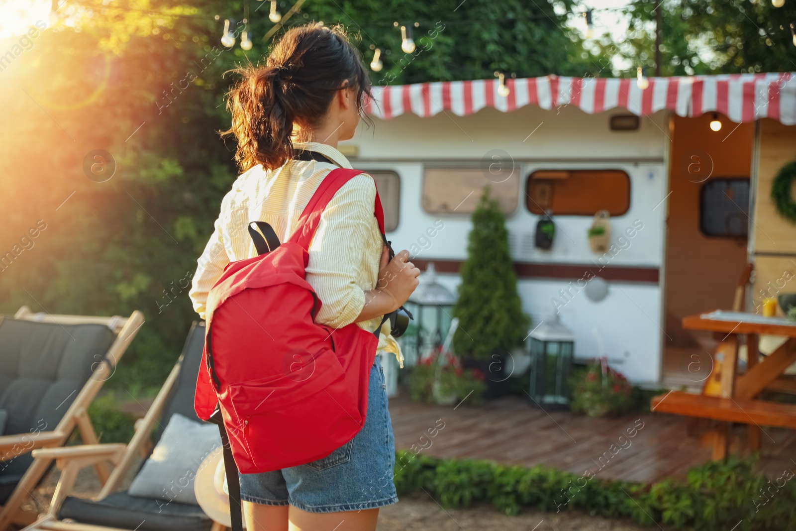 Photo of Young traveler with backpack outdoors. Summer trip