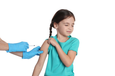 Photo of Doctor vaccinating little child on white background