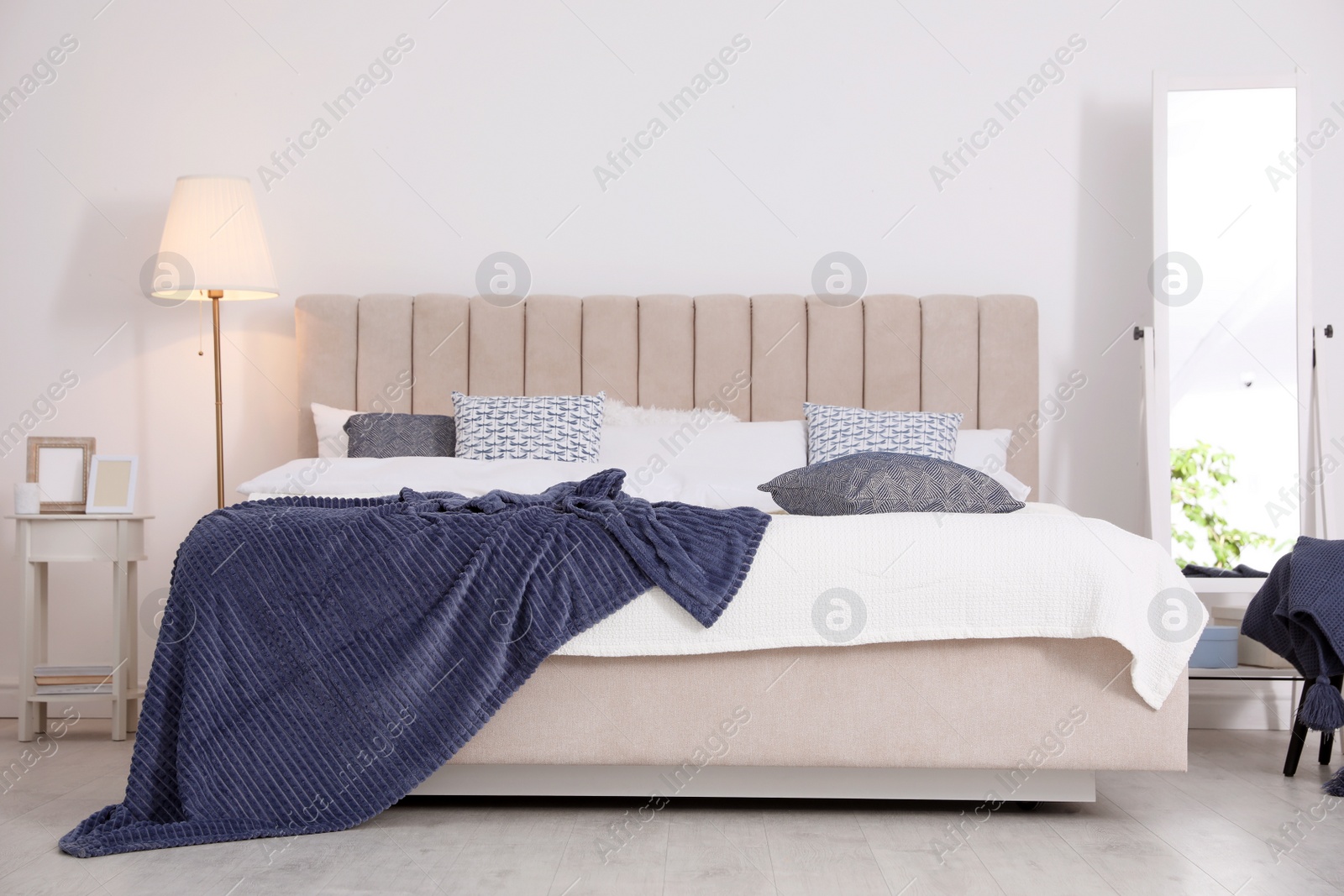 Photo of Comfortable bed with pillows in room. Stylish interior design