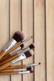 Makeup brushes on wooden background