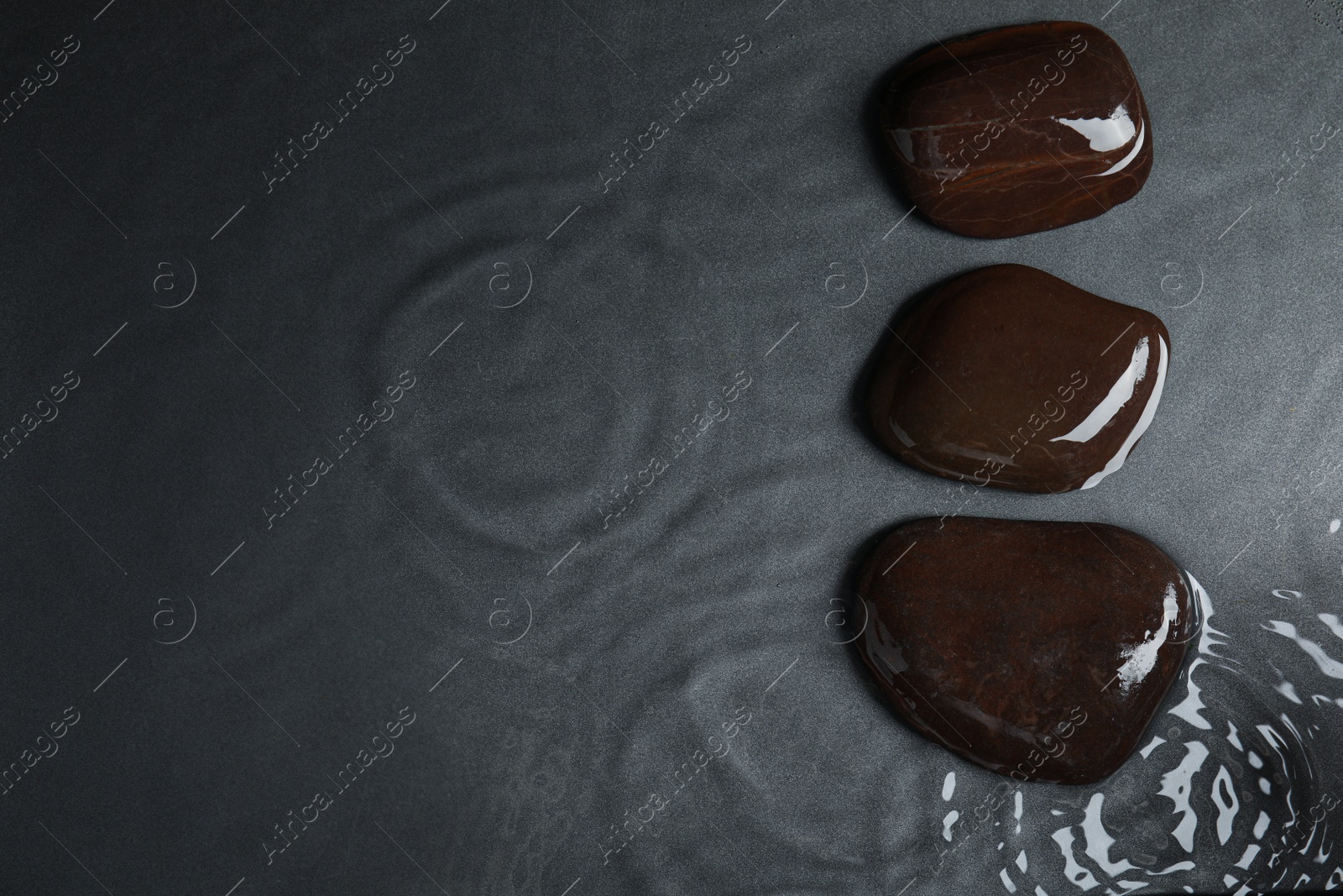 Photo of Stones in water on grey background, flat lay with space for text. Zen lifestyle