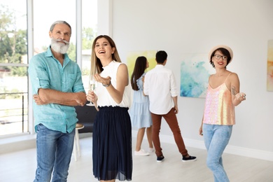 Group of people at exhibition in art gallery