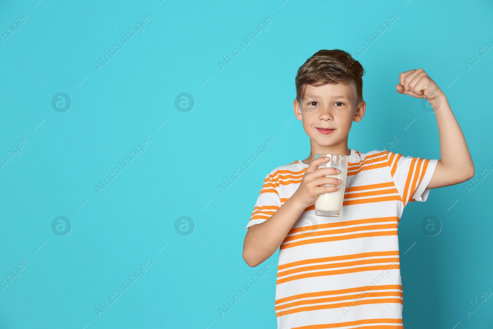 Photo of Adorable little boy with glass of milk on color background