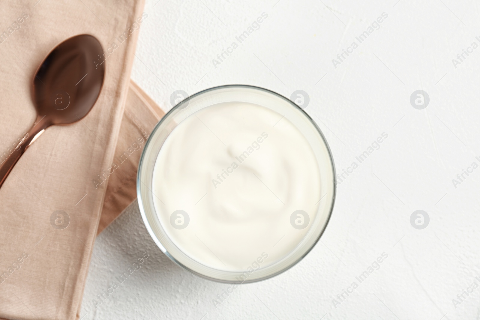 Photo of Bowl with yummy yogurt on light background