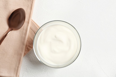 Photo of Bowl with yummy yogurt on light background