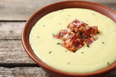 Photo of Tasty potato soup with bacon in bowl on table, closeup