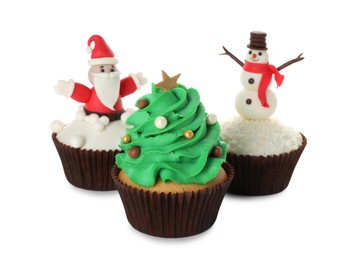 Different beautiful Christmas cupcakes on white background