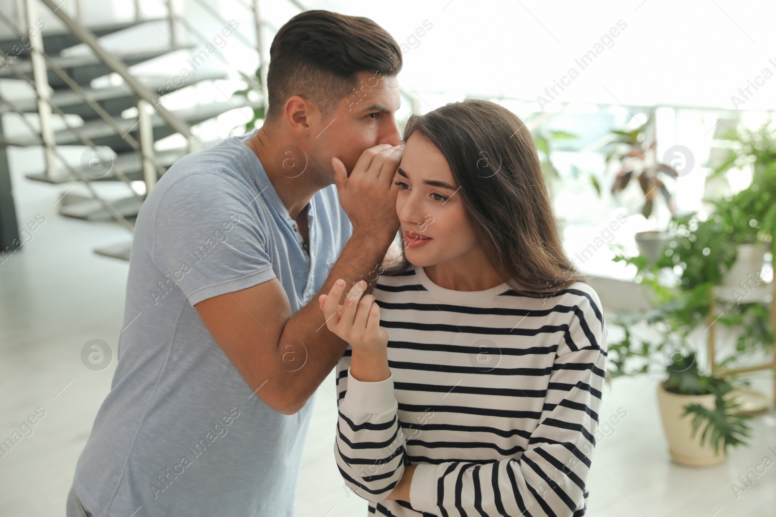 Photo of Man and woman having conversation in hall