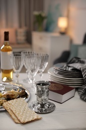 Table served for Passover (Pesach) Seder indoors, space for text