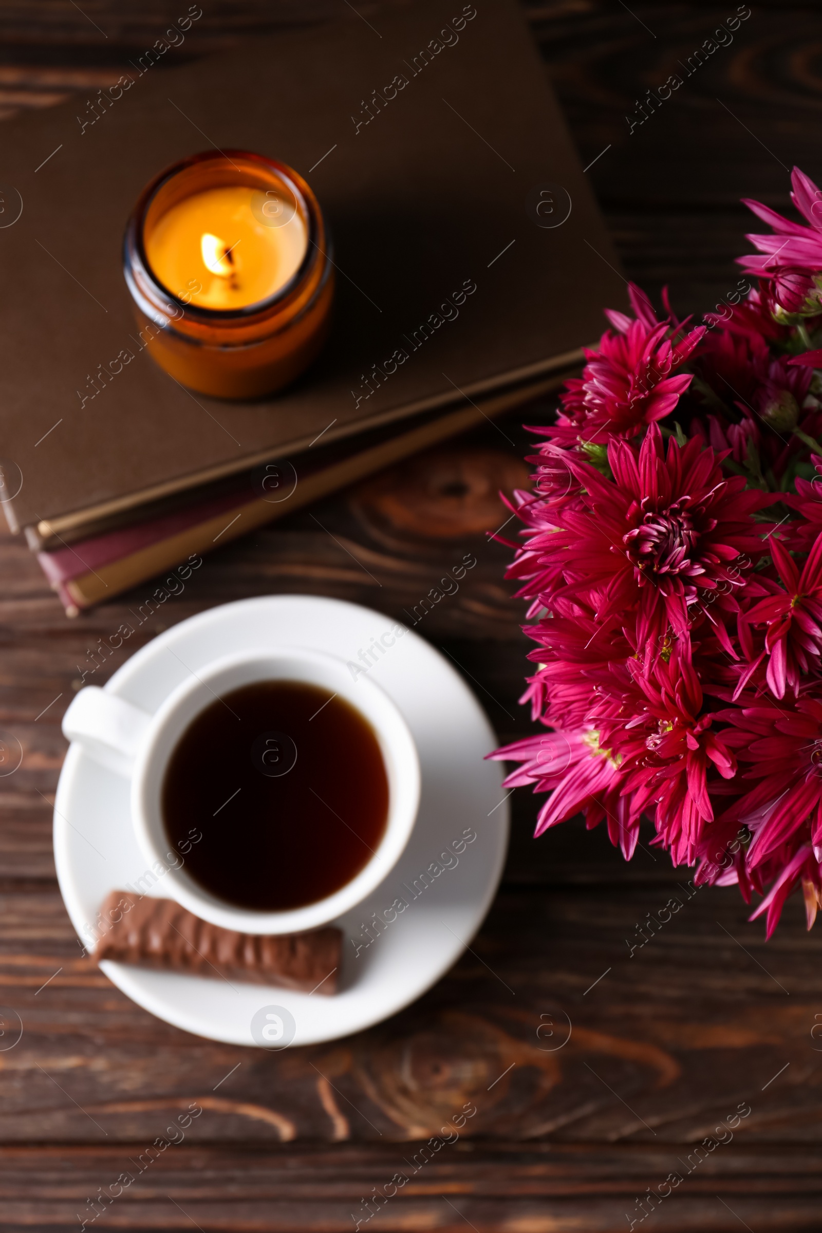 Photo of Flat lay composition with beautiful pink chrysanthemum flowers and cup of aromatic tea on wooden table