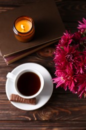 Photo of Flat lay composition with beautiful pink chrysanthemum flowers and cup of aromatic tea on wooden table