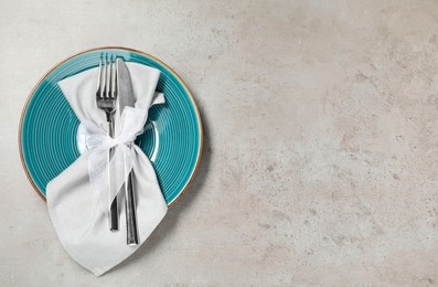 Photo of Setting with beautiful cutlery on textured table, top view. Space for text