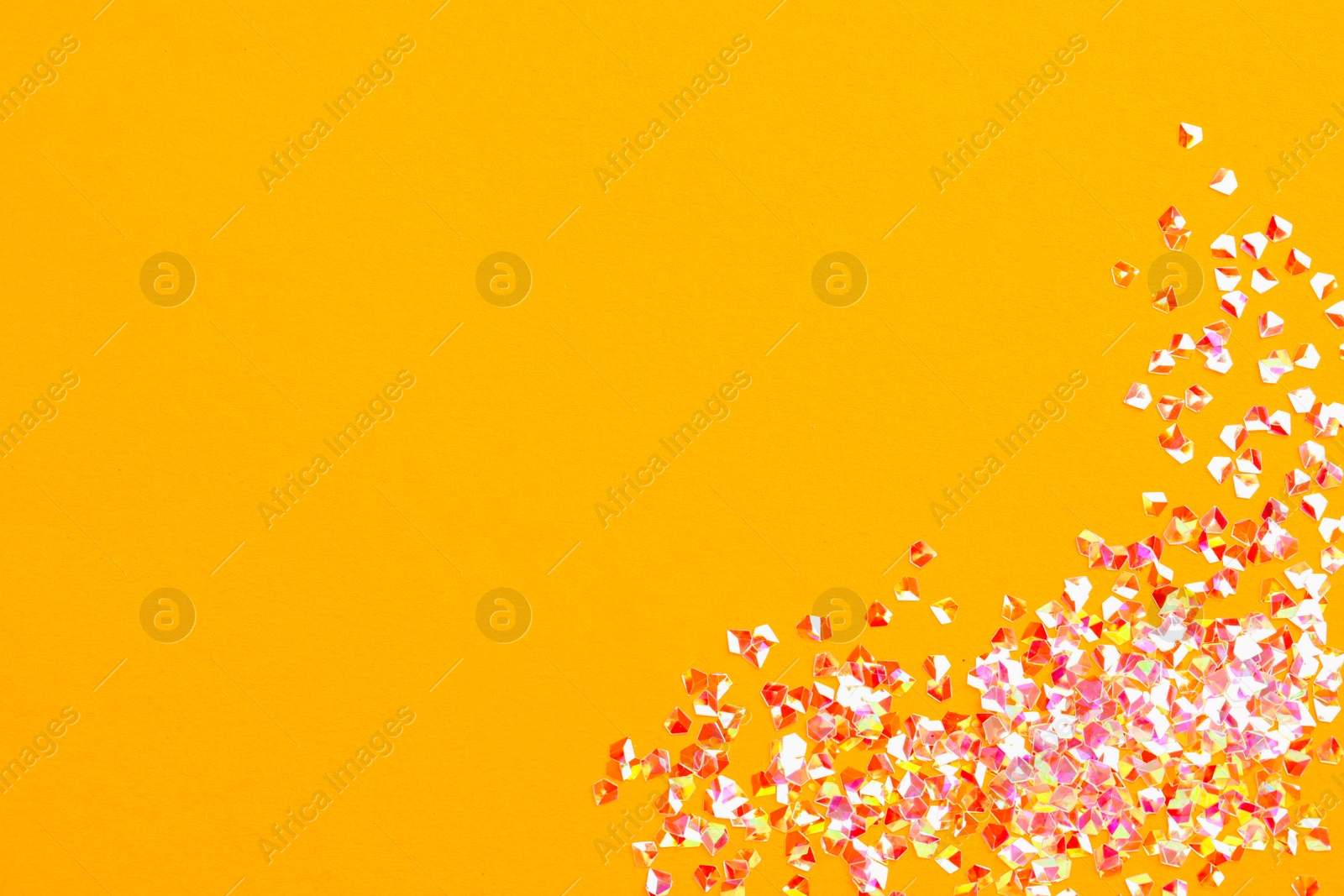 Photo of Pile of shiny glitter on orange background, flat lay. Space for text