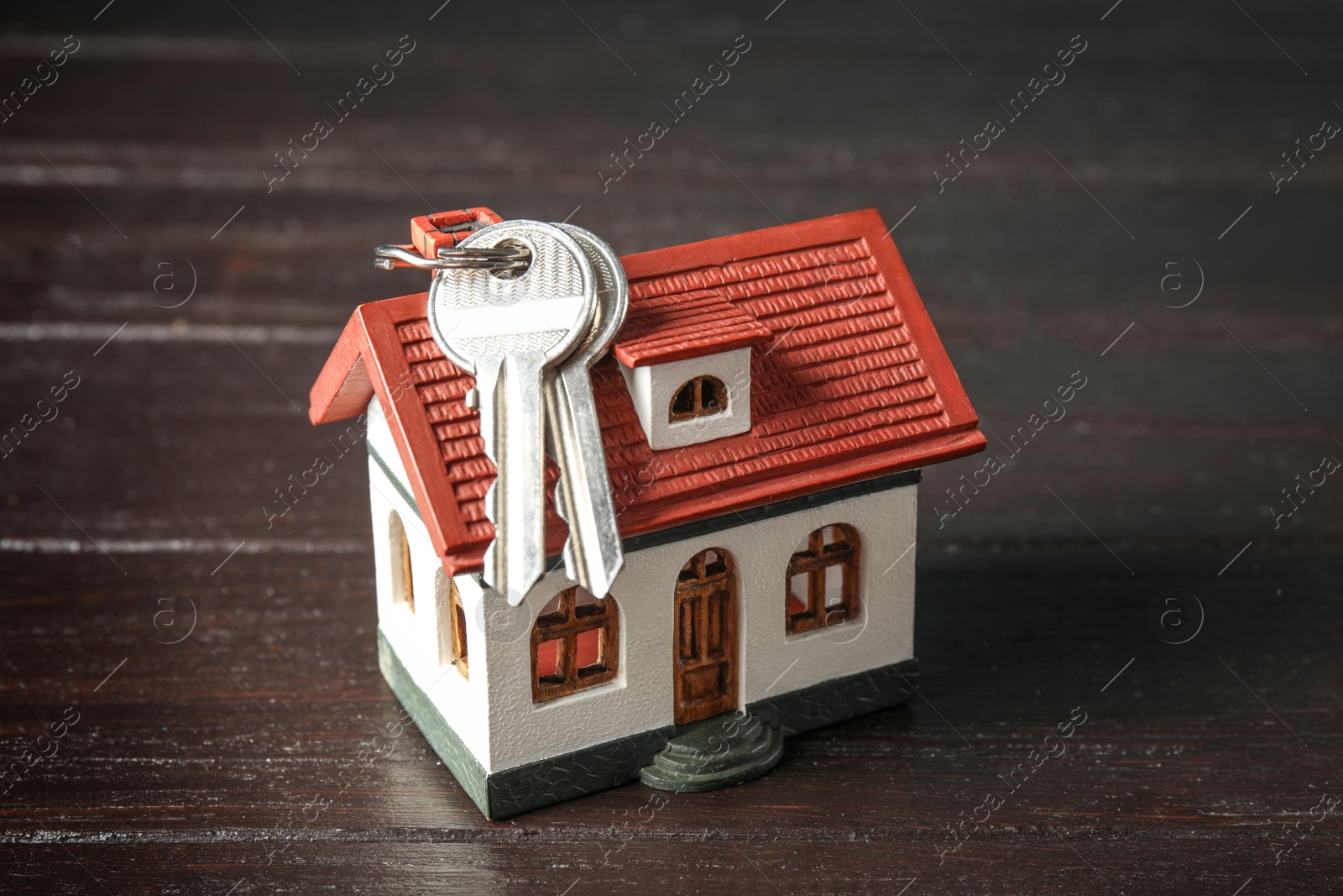 Photo of House model and keys on wooden background