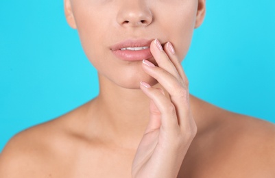 Closeup view of beautiful young woman on color background. Lips contouring, skin care and cosmetic surgery concept