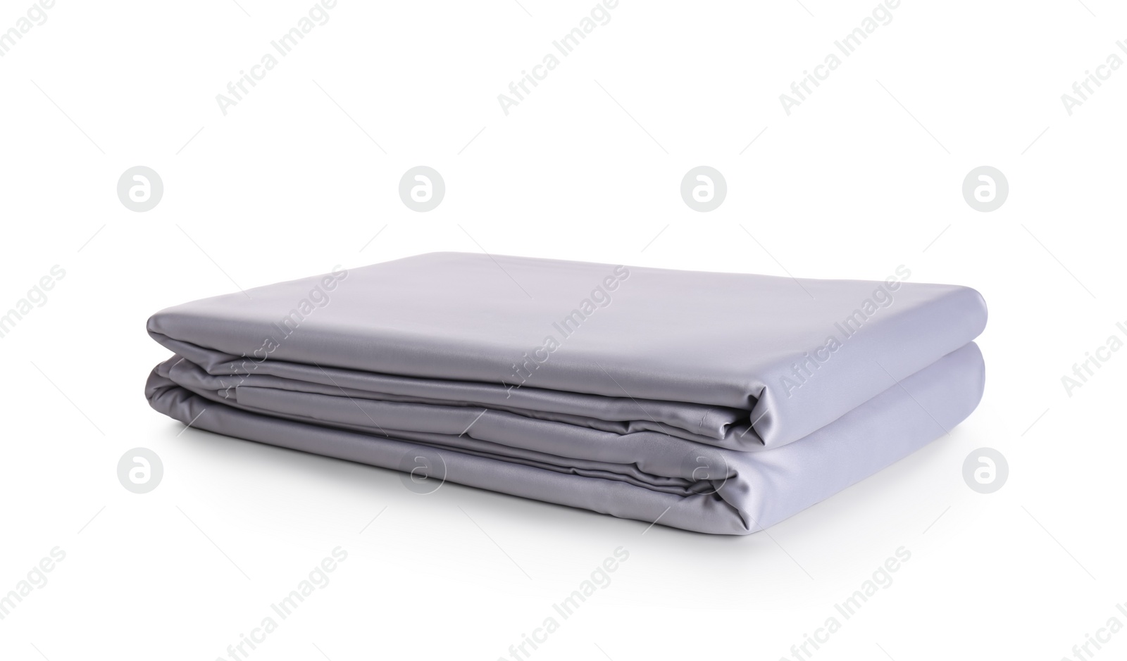 Photo of Stack of clean silky bed linen isolated on white