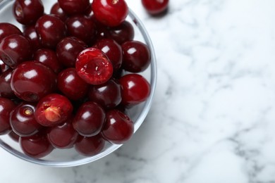 Photo of Sweet juicy cherries on white marble table, top view. Space for text
