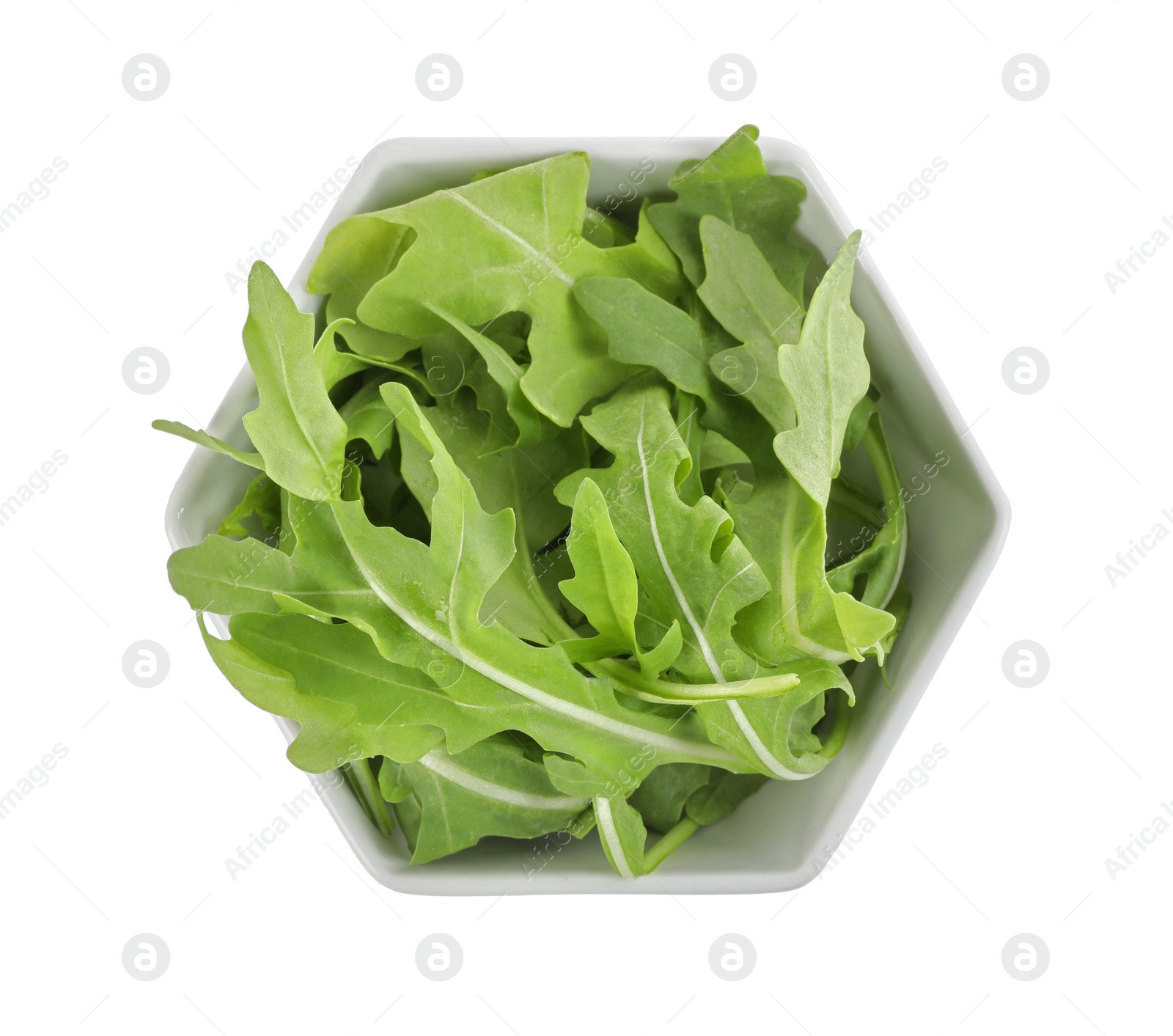 Photo of Delicious fresh arugula in bowl isolated on white, top view