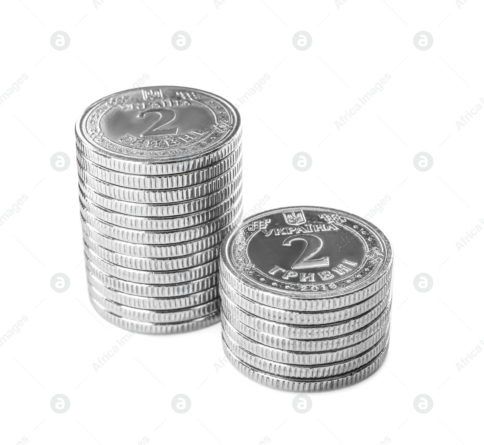 Photo of Stacks of Ukrainian coins on white background. National currency