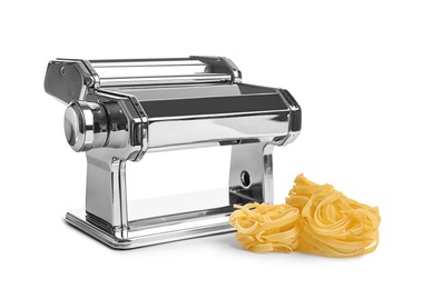 New pasta machine and uncooked noodles on white background