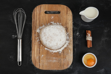 Photo of Flat lay composition with raw eggs and other ingredients on black background. Baking pie