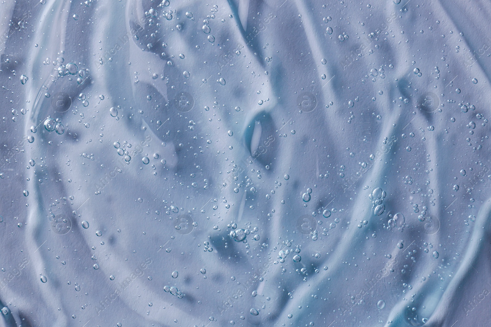 Photo of Texture of transparent shower gel as background, closeup