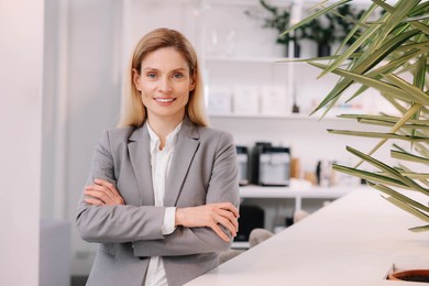 Photo of Female real estate agent indoors. Space for text