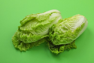 Photo of Fresh ripe Chinese cabbages on light green background