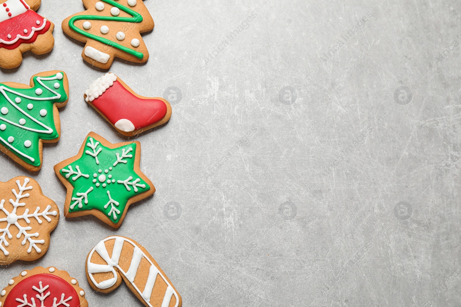 Photo of Flat lay composition with tasty homemade Christmas cookies on grey table, space for text