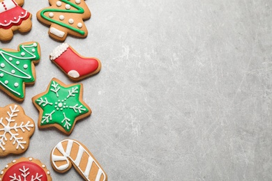 Flat lay composition with tasty homemade Christmas cookies on grey table, space for text